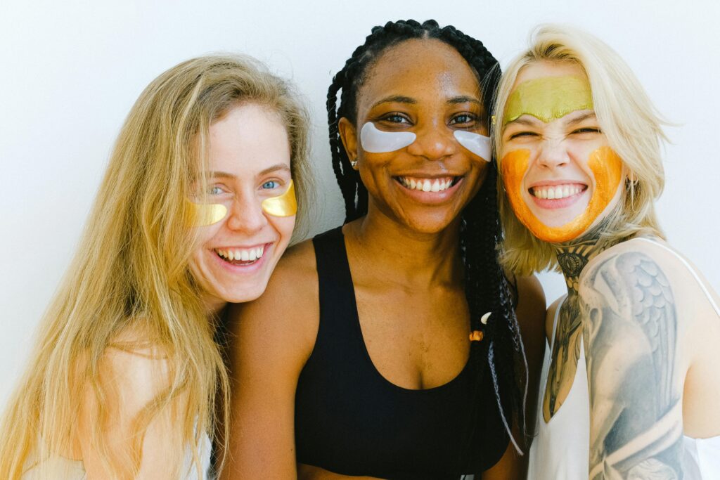 pexels-photo-3851696-3851696 Group of women with masks and patches smiling while looking at camera and laughing during skincare procedure in studio on weekend